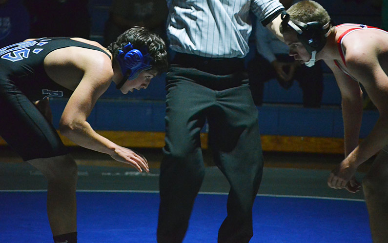 Polk County freshman Christian Davis prepares to the start the second period of his 132-pound match with Landrum's Bill Kuykendall.