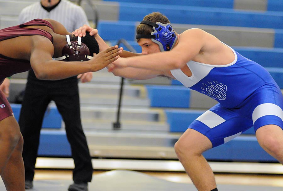 Polk County's Braden Miller begins his match with Owen's Kameron Harper
