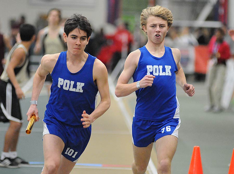 Jacob Wolfe, left, takes a handoff from Jeremy Allsbrook during the 4x800-meter relay.
