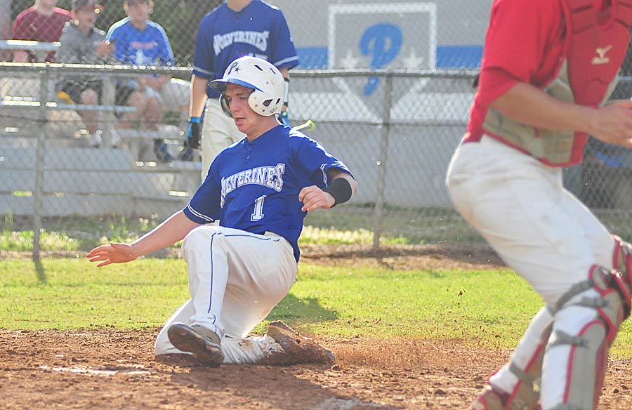 Pinch runner Zane Johnson slides into home with a run Tuesday for Polk County.