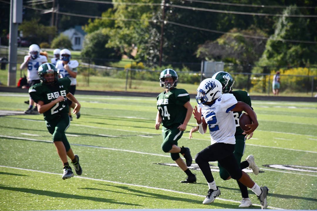 Polk Middle's Hollis Williams races past the Flat Rock defense in Thursday's win (photo courtesy Natalie Serrano)