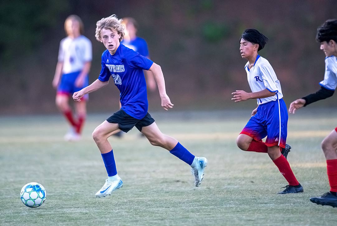 Polk Middle's Brennan Oates looks to avoid two Rugby defenders and find an open teammate during Wednesday's match