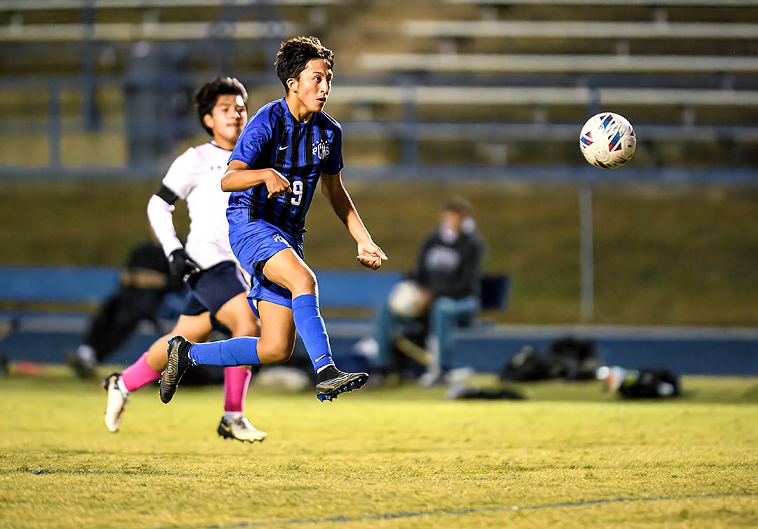 Polk County's Manny Albarran charges toward the Chase goal during the first half of Monday's match
