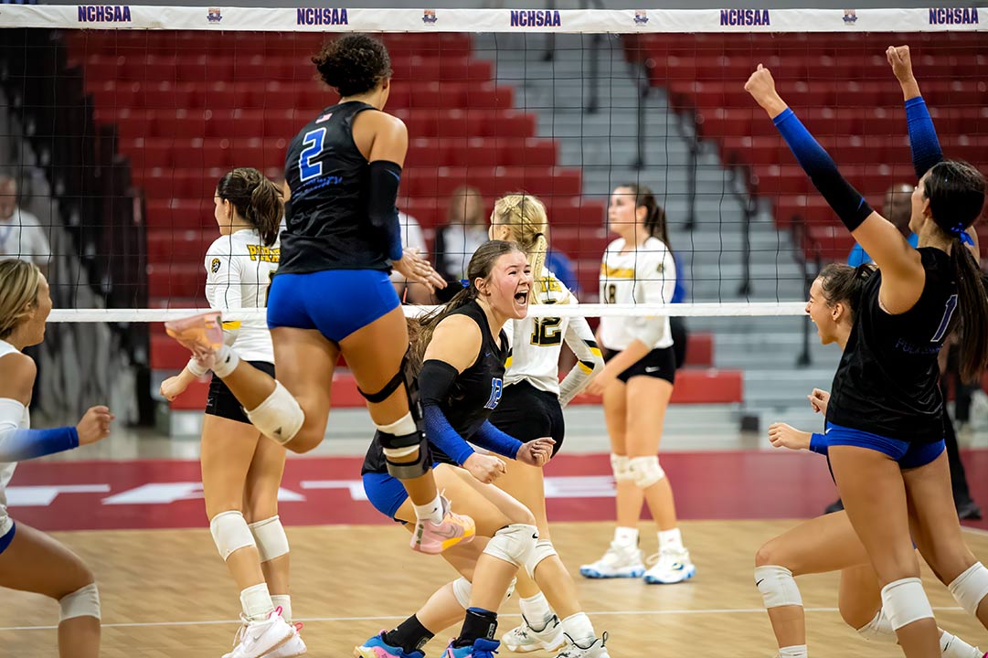 Kylie Lewis turns to celebrate with her Polk County teammates after winning match point Saturday