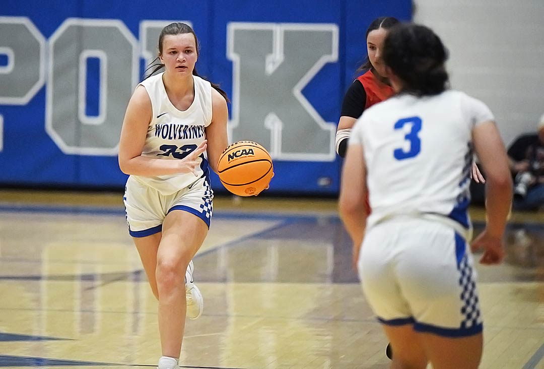 Polk County's Jayden Duncan pushes the ball upcourt to teammate Bailey Staton during the first half of Tuesday's game