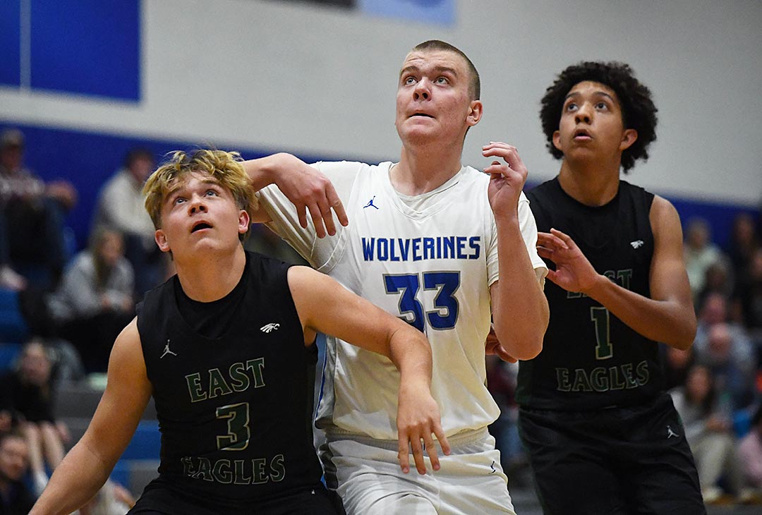 Polk County's David Duffy battles East Henderson players for a rebound during action earlier this season