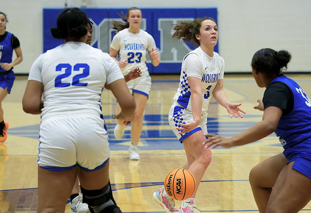 Polk County junior Bailey Staton dishes a no-look pass Friday to Kiera Littlejohn for one of her five assists