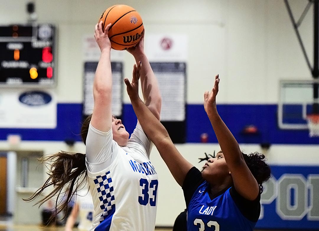Polk County's Kylie Lewis hauls in a rebound during the first half of Tuesday's game