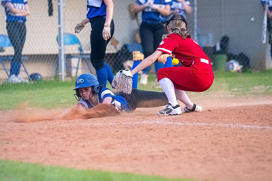 Polk County's Kinsley Lancaster slides home following a wild pitch during Tuesday's game against Hendersonville