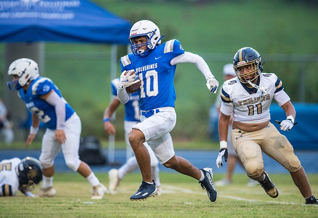 Polk County's Jesse Moore races upfield with a kickoff return during the first quarter of Friday's game with Chase