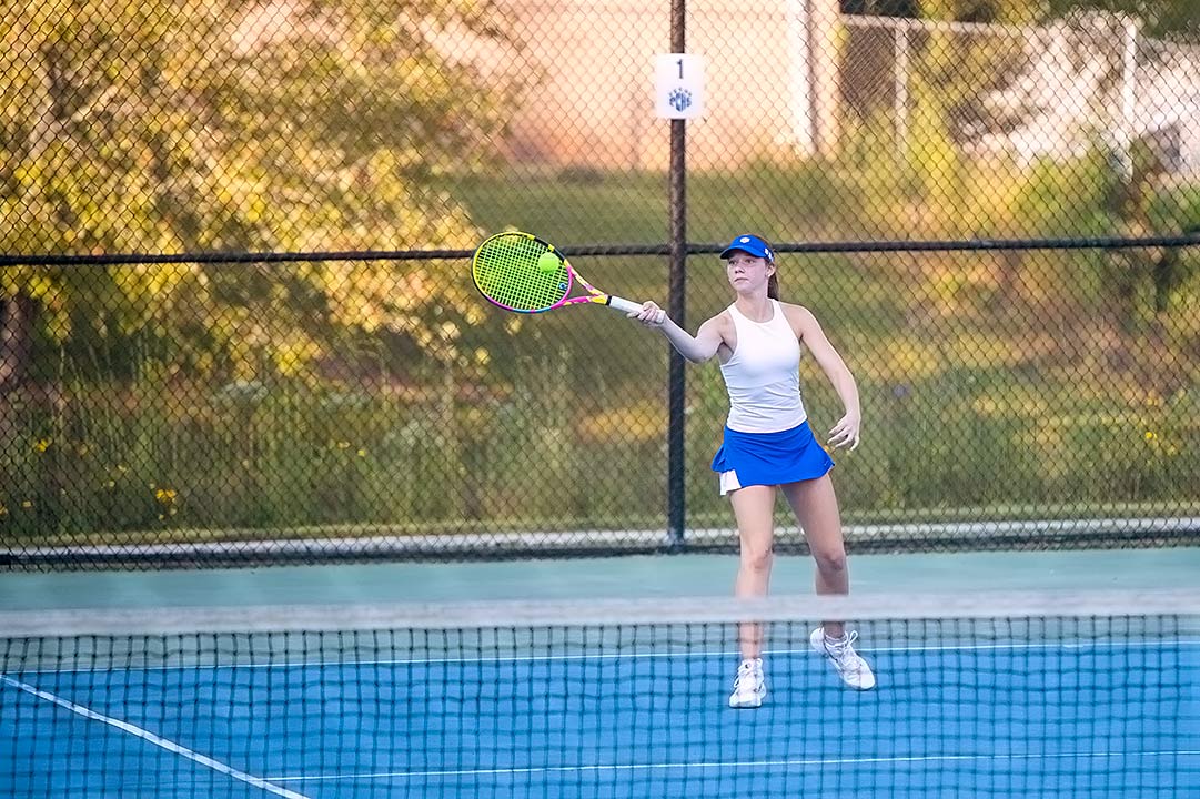 Polk County's Jill Brown delivers a return during Monday's doubles match
