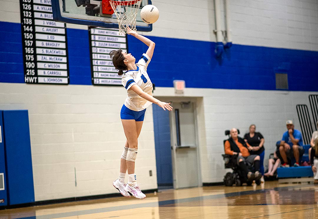 Polk County's Jessie Bradley soars for a serve during Tuesday's match