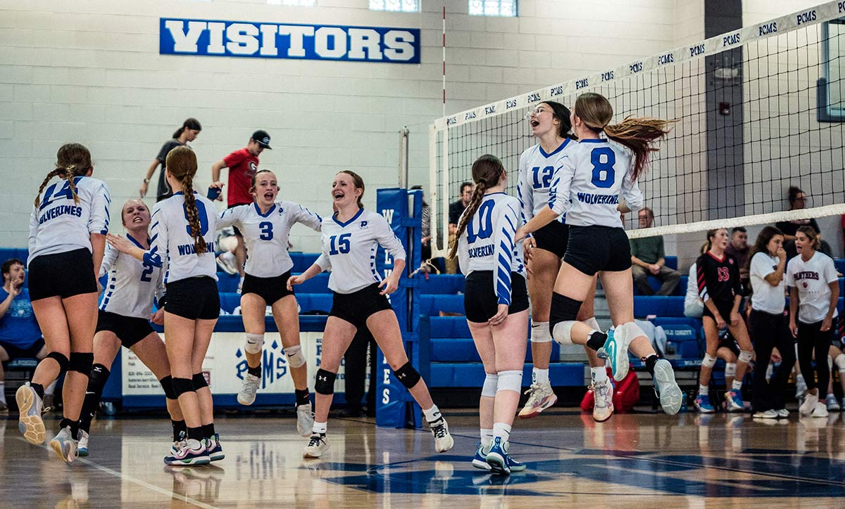 Polk Middle players celebrate Wednesday's victory in three sets over Macon Middle (Caleb Russell photo)